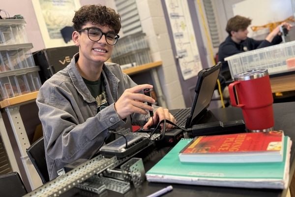 An Oakland Christian student works at his desk.