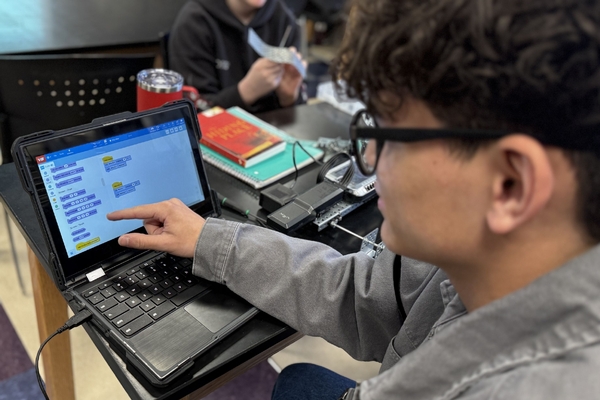 An Oakland Christian student points to the program he's using on his laptop.