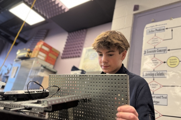An Oakland Christian student works with metal components at school.