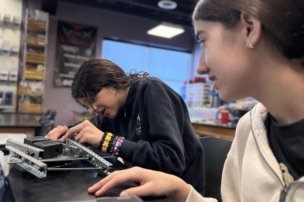 Two Oakland Christian girls work hard on their engineering project.