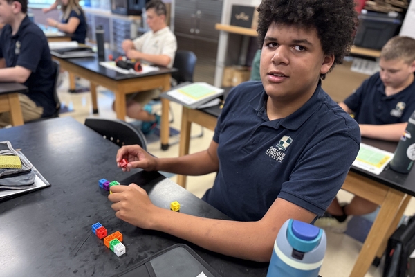 An Oakland Christian student builds with cubes at his table.