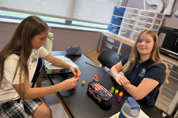 Two Oakland Christian girls work together at their table in STEM class.