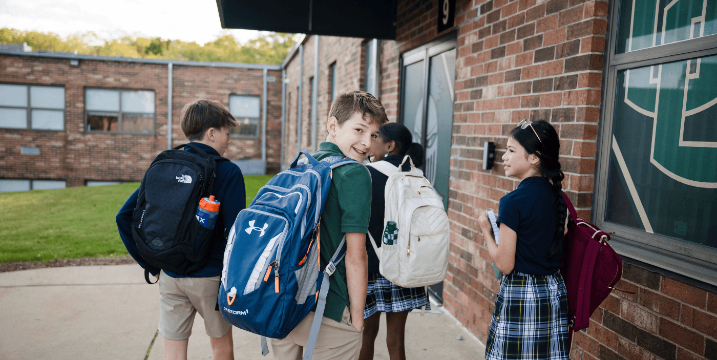 Students walking outside of the school building