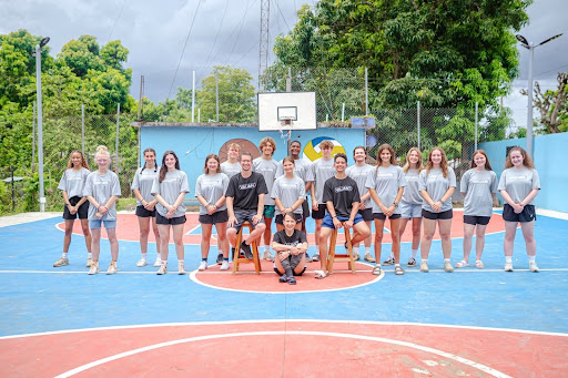 Oakland Christian students and Señora Frasa smile for a photo in the Dominican Republic on an annual mission trip.